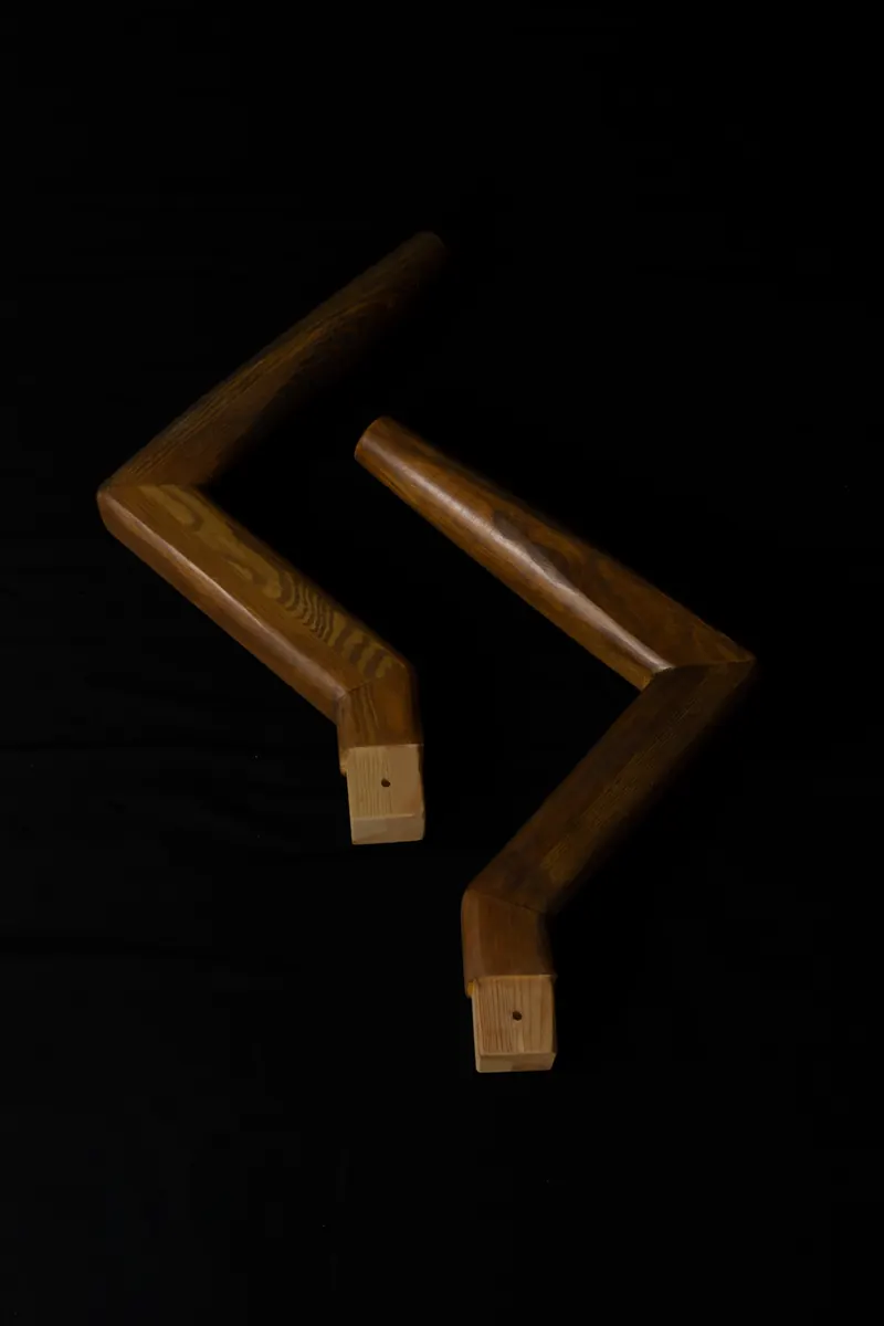 Two wooden L arms bent at 90 degrees